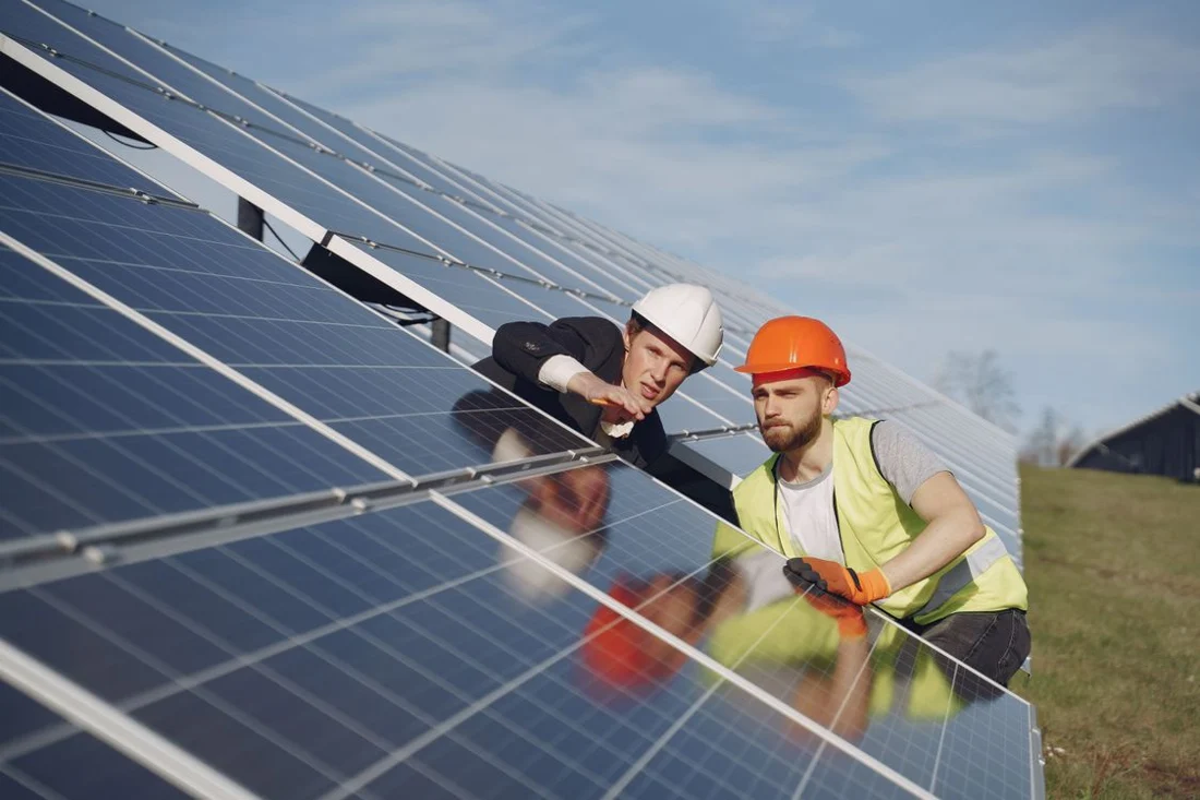 Technicians assessing photovoltaic panels